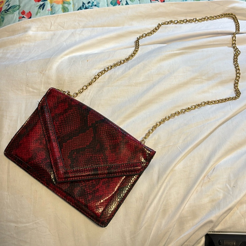 Faux red and black snakeskin clutch purse with gold chain strap